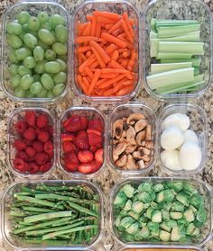 six plastic containers filled with different types of vegetables and fruits next to each other on a marble surface