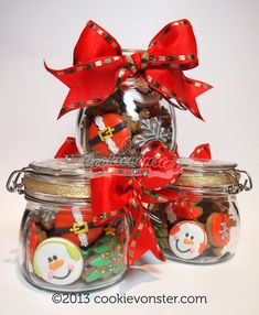 a glass jar filled with christmas cookies and candy