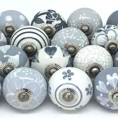 a bunch of different colored and shaped knobs on a white surface with flowers painted on them