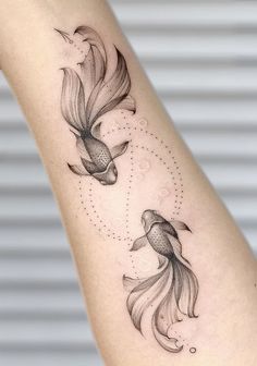 two goldfish tattoo on the arm