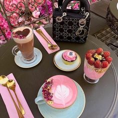 a table topped with plates and cups filled with desserts