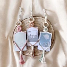 three pictures are hanging on a rope with tassels and beads around them, in the shape of an ornament