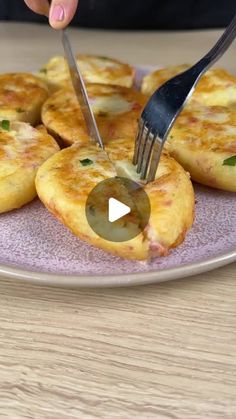 a person cutting up some food on a plate with a knife and fork in it