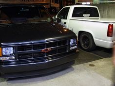 two pickup trucks parked next to each other