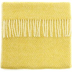 a yellow and white blanket with fringes on it