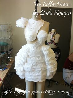 a dress made out of paper sitting on top of a mannequin