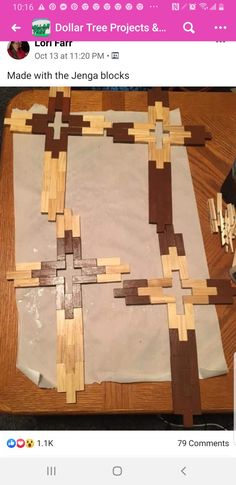 an image of a wooden cross made out of wood planks on top of a table