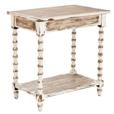 an old white wooden table with beaded legs