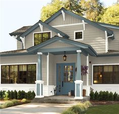 a blue front door on a white house