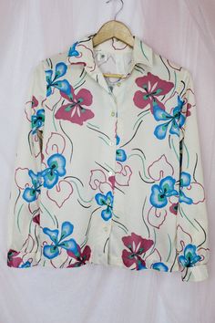 "Beautiful 70's Floral Print Button up Blouse..100% polyester. Perfect Condition No stains or tears. Pair this with Skirts or Levis. Pre Love Great Condition 70's Vintage Blouses Size Small Actual Measurements are.. Shoulder to Shoulder: 15 1/2\" Armpit to Armpit: 19 1/2\" Sleeves: 22 1/2\" Length: 24\" Shipping from 3-5 Days No Returns or Exchanges Thank you for Visiting..:)" Retro Button-up Shirt In Multicolor Print, Retro Multicolor Print Button-up Shirt, Retro White Printed Blouse, Retro Button-up Shirt With Multicolor Print, Spring Retro Button-up Blouse, Retro Spring Blouse With Buttons, Retro Spring Blouse With Button Closure, Retro Button-up Blouse For Spring, Retro Multicolor Print Button-up Tops