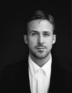 a man in a suit and white shirt posing for a photo with his eyes wide open