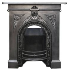 an ornate fireplace with a black mantle and metal trimming on the top, against a white background