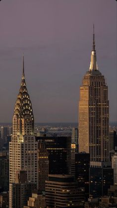 the empire building in new york city is lit up at night