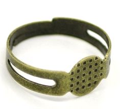 an old bronze ring with holes in the middle on a white background, close up