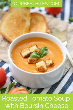 roasted tomato soup with bourssin cheese in a white bowl on a blue and white table cloth