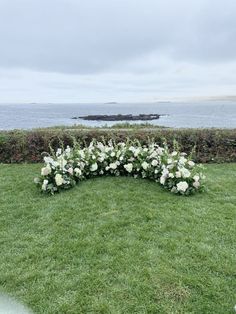 an arrangement of white flowers is arranged on the grass