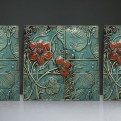 three pieces of art with red flowers on them