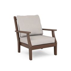 a wooden chair with a cushion on the back and armrests, sitting in front of a white background