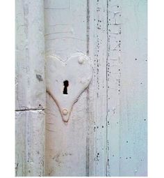 a white door with a heart shaped keyhole