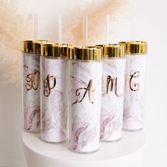 four personalized marble tumbles with gold caps