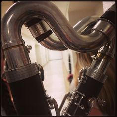 a close up of a metal pipe on the back of a bike in a building