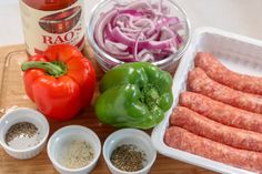 sausage, peppers, onions and spices on a cutting board