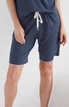 Inspired by vintage French bloomers, these cozy sleep shorts are updated with our signature modern-minimalist style. Super soft against the skin, these pj bottoms feature contrast tipping at the hem for a refined finish. They’re the loungewear-luxe shorts you’ve been waiting to dream in. Lightweight organic cotton blend knit Drawstring waistband with one button closure on placket Contrast stripe at hem in ivory Model is a size 4 and wears a size small Inseam length is 9" for size small Machine w Athleisure Bottoms With Contrast Trim For Loungewear, Summer Loungewear Bottoms With Contrast Trim, Loungewear Pajama Shorts With Elastic Waistband, Contrast Trim Loungewear Bottoms Short Length, Cotton Knee-length Pajama Shorts For Loungewear, Athleisure Pajama Shorts With Short Inseam For Loungewear, Athleisure Pajama Shorts With Short Inseam, Athleisure Pajama Shorts For Loungewear, Mid-thigh Cotton Bottoms For Loungewear