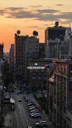 the sun is setting over a city with tall buildings and cars parked on the street