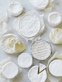 several pieces of cheese sitting on top of a white countertop next to each other