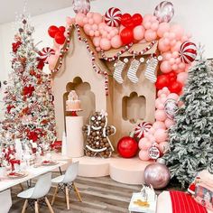 a room decorated for christmas with balloons and decorations