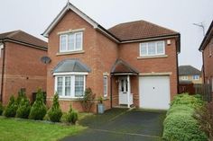 a two story brick house with white trim