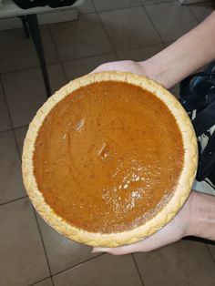 a person holding a pie in their hands