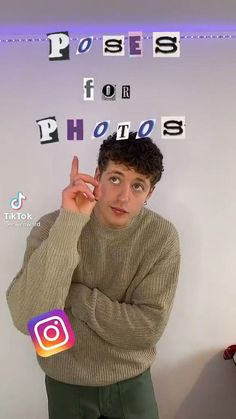 a man standing in front of a white wall with the words photos spelled on it