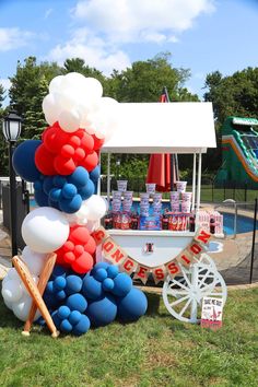 an ice cream cart decorated with balloons and streamers