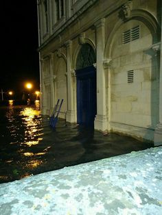 a flooded street at night with water covering the ground