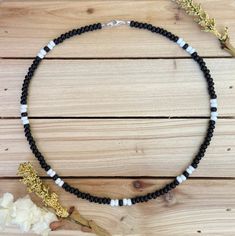 The Black & White beaded choker can go with any outfit. Whether you are out at dinner or a party on the beach, this choker is just what you need! All chokers are customizable to the size you need so please be sure to measure your neck where you want your choker to sit and order accordingly! This Seed Bead Necklace For Men, Summer Beaded Necklace With Black Round Beads, Black Heishi Beads For Beach, Summer Black Beaded Round Necklaces, Black Beaded Necklaces With Spacer Beads For Beach, Black Beaded Necklace For Beach With Tiny Beads, Black Beaded Necklaces For Beach, Beach Black Beaded Necklace With Tiny Beads, Black Beaded Choker For Beach