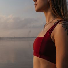 Details The long-awaited piece for wave dancers seeking elegance and style. Inspired by retro designs, this surf bikini top features a square neckline and backline with wider shoulder straps, providing both comfort and support. The vertical stitching on the front and back creates a beautiful upper body shape that will turn heads on the beach. Crafted with premium quality Econyl lycra recycled from ocean plastic, this bikini top not only looks great but also supports sustainability. Pair this top Square Neck Crop Top For Beach, Fitted Swimwear With Adjustable Straps, Fitted Cropped Swimwear With Adjustable Straps, Fitted Bra-friendly Swimwear With Square Neck, Bra-friendly Fitted Square Neck Swimwear, Cropped Beach Swimwear With Adjustable Straps, Cropped Swimwear With Adjustable Straps For Beach, Beach Swimwear With Bra-friendly Wide Straps, Surfing Swimsuit