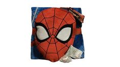 a spiderman mask on top of a blue blanket