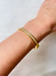 Stunning shiny Cubic Zirconia 18k gold plated bangle bracelet. Perfect for your bracelet stack collection. You can easily style it with every outfit day or evening, casual or occasional. Perfect piece to elevate your look! Made with most durable stainless steel material. So you could enjoy our creations for longest time. C A R E T I P S ✔️ Please remove jewelry before showering, swimming and sleeping. ✔️Avoid direct use of perfumes, lotions or other harsh chemicals on the item. ✔️Store in a cool dry place, ideally in a separate compartments to prevent scratching. ✔️Gently wipe jewelry with a polishing cloth to clean and maintain shine. Why jewelry is made from from Stainless steel? Stainless steel ranks 6th on the Mineral Hardness rank, while others such silver ranks at 2.5. That means sta Trendy Gold Cubic Zirconia Tennis Bracelet, Trendy Gold-plated Tarnish-resistant Bangle, Minimalist Tarnish Resistant Cubic Zirconia Bracelet, Trendy Gold-plated Bangle For Gift, Minimalist Bangle Tennis Bracelet Gift, Tarnish Resistant Gold Plated Diamond Bangle Bracelet, Tarnish Resistant Gold Plated Diamond Bangle, Trendy Gold Cubic Zirconia Bracelet, Gold Cubic Zirconia Minimalist Bracelet