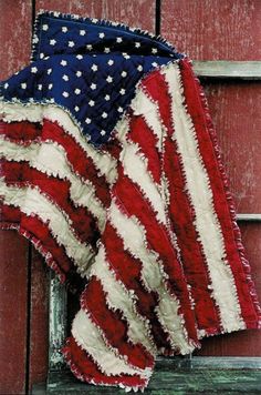 an american flag is hanging on the side of a building