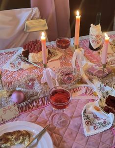 a table topped with lots of food and candles