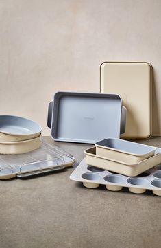 several different types of pans and trays on a table