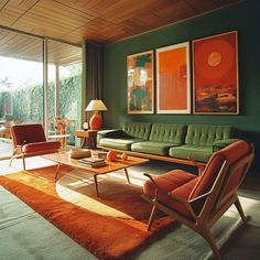 a living room filled with green furniture and orange rug on top of a wooden floor