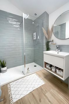 a bathroom with a sink, mirror and shower in it's center piece is shown