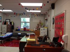 an office with desks, chairs and bulletin board