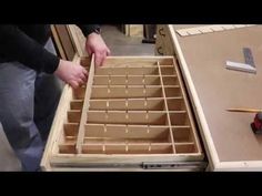 a person is working on an unfinished drawer