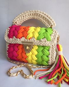 a multicolored handbag with a tasselled handle