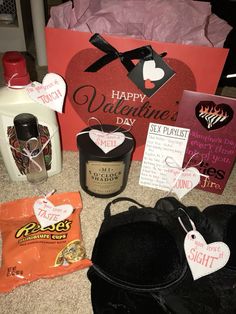 valentine's day gifts are laid out on the floor next to bags and bottles