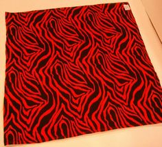 a red and black pattern on a white surface