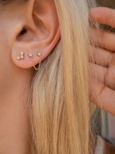 a close up of a person wearing ear piercings